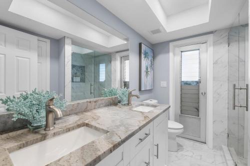 a bathroom with a sink and a toilet at Waterfront Oasis in Cape Coral
