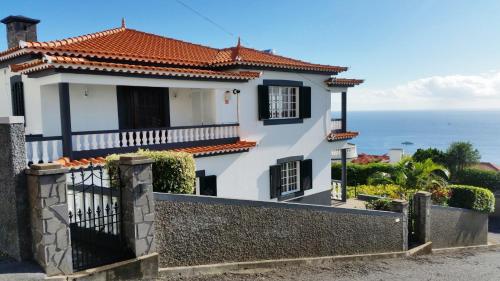 a house with a view of the ocean at Charming Apartments in Funchal - São Gonçalo in Funchal