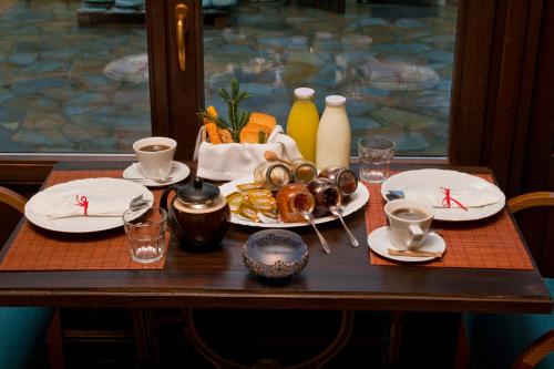 a table with plates of food and drinks on it at 4 Seasons in Vizitsa in Vizitsa