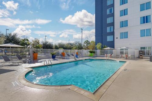 a swimming pool in front of a building at Hilton Garden Inn Houston NW America Plaza in Houston