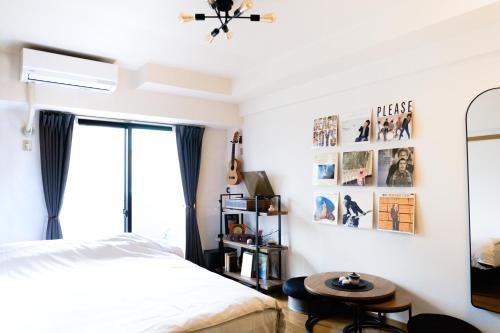 a bedroom with a bed and a table at MINIMAL SHIMOKITA Stylish Loft or Studio Apt in Tokyo