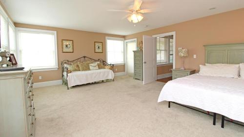 a bedroom with two beds and a ceiling fan at 209 Congress Street in Cape May