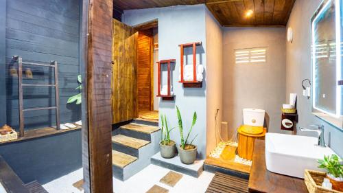 a bathroom with a toilet and a sink at Cozora Nook - Sigiriya in Sigiriya