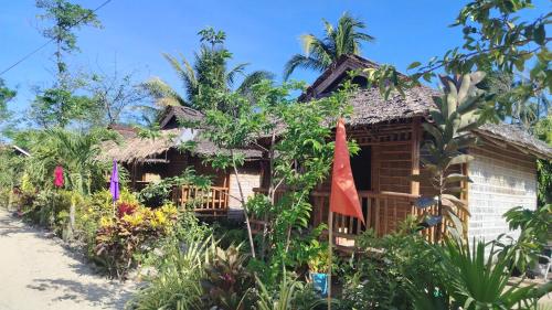 a house in the middle of a garden at Bamboo Basecamp in El Nido