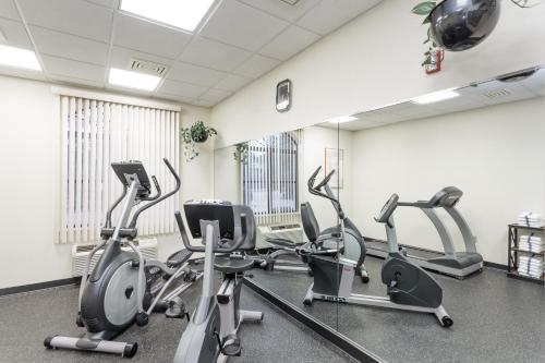 a gym with cardio bikes and ellipticals in a room at Baymont by Wyndham Asheville/Biltmore in Asheville