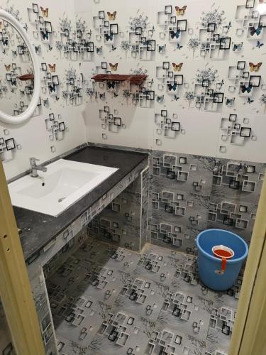 a bathroom with a sink and a mirror at HAnsHari Homestay in Kuttālam