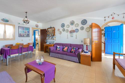 a living room with a purple couch and a table at Villa Lia Panorama in Pefki Rhodes