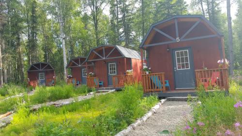 a group of small houses in the woods at DFA Cabin Rentals in Talkeetna