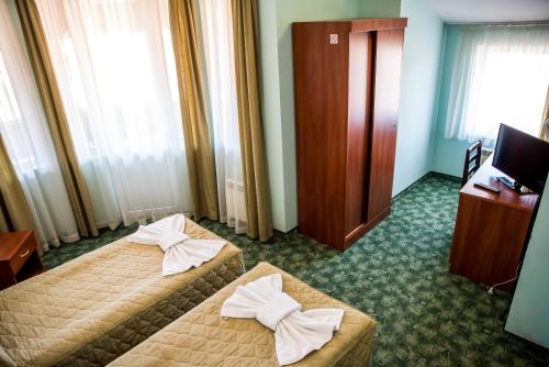 a hotel room with two beds with bows on them at Bariakov Family Hotel in Bansko