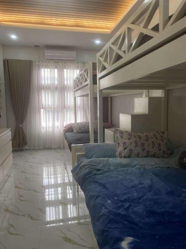 a bedroom with two bunk beds with blue sheets at Balay Buenavista in Magdalena