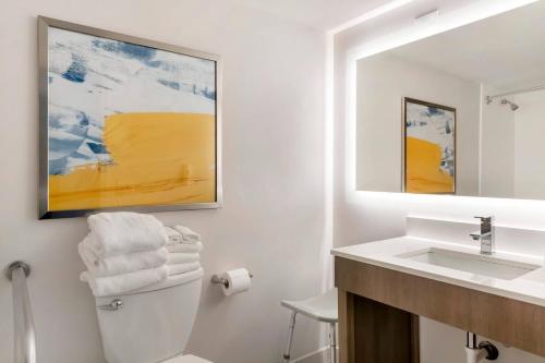 a bathroom with a sink and a toilet and a mirror at Comfort Inn Eagan Minneapolis - St Paul South in Eagan