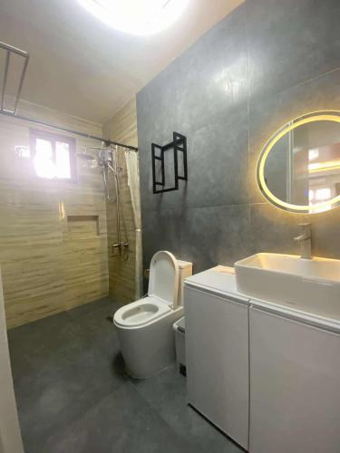 a bathroom with a white toilet and a sink at Balay Buenavista in Magdalena