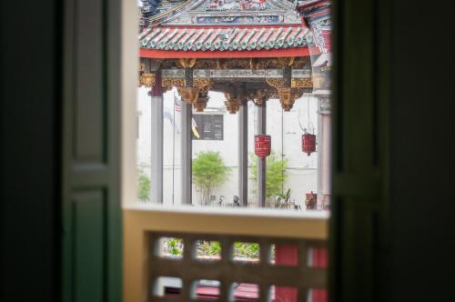 a view of a building through a window at Aceh Suites by Aayu - 1 min walk to Armenian St in George Town