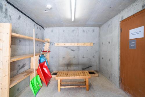 a room with a bench and a table in it at Goodfellas Onsen House in Niseko