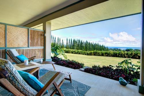 a patio with chairs and a view of the ocean at Mahana House Country Inn in North Hilo