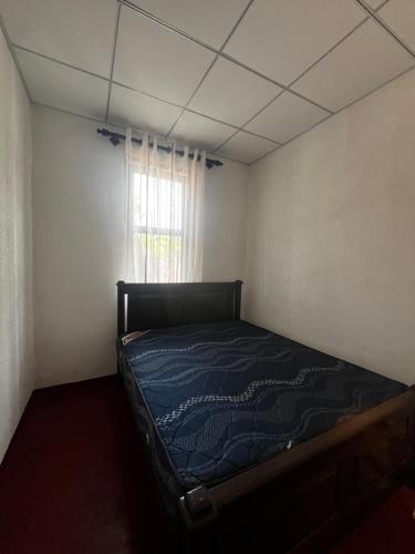 a bedroom with a bed in a room with a window at Maria Ceylon Villa in Tangalle