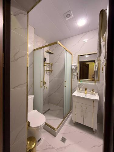 a bathroom with a shower and a toilet and a sink at GUZAL Hotel PREMIUM in Bukhara