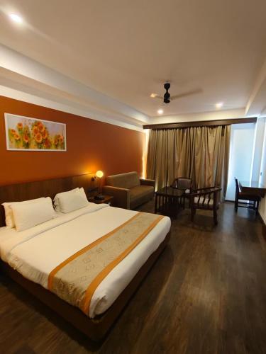 a bedroom with a large bed and a living room at HOTEL SKY PARADISE in Iritti