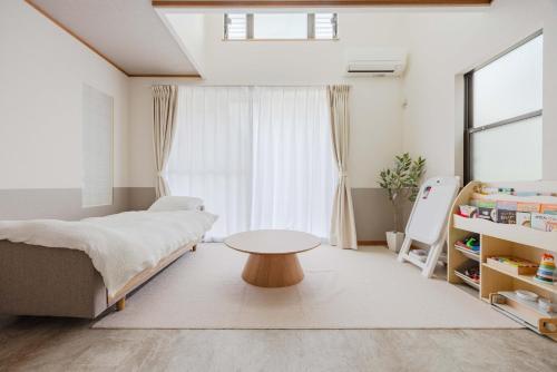 a bedroom with a bed and a table at Nagoya Homestay in Nagoya