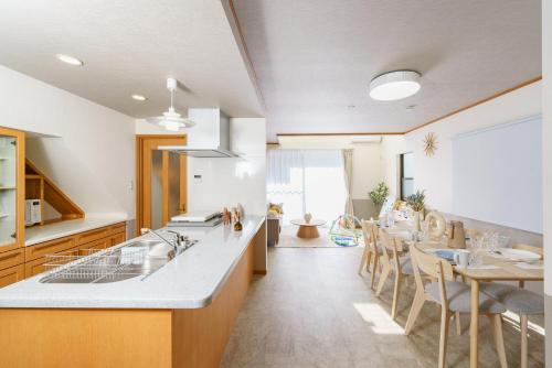 a kitchen and dining room with a table and chairs at Nagoya Homestay in Nagoya