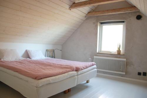 a bedroom with a bed and a window at Drängagården in Klagstorp