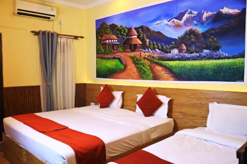 two beds in a room with a painting on the wall at Hotel Peaceland Lumbini in Rummindei