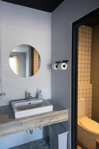 a bathroom with a sink and a mirror at Free Way Kata Beach Hostel in Kata Beach
