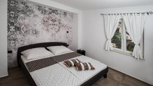 a bedroom with a bed with two pillows on it at Villa Estate 2 by Villas Guide in Kornić