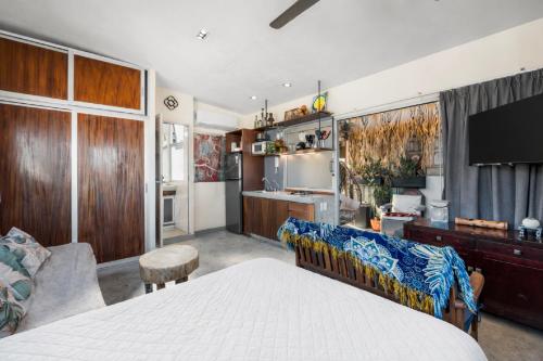 a bedroom with a bed and a living room at Romantic Zone in Puerto Vallarta