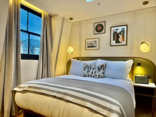 a bedroom with a large bed and a window at The Barkston in London