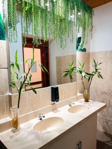 a bathroom with two sinks and a large mirror at Hostel Prada in Lima