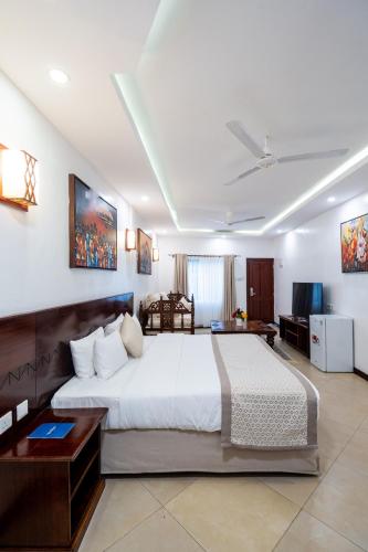 a bedroom with a large bed in a room at PrideInn Hotel Nyali in Mombasa