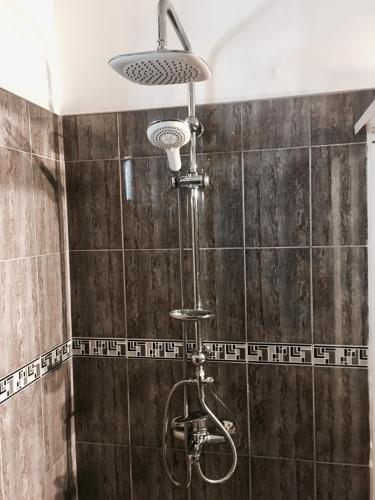 a shower with a shower head in a bathroom at Villa Riverplace in Beruwala