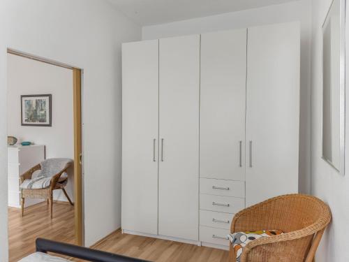 a bedroom with white cabinets and a mirror at Objekt-Nr 247 - Hafen - Kurgartenstraße in Travemünde