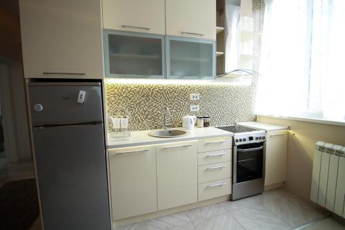 a small kitchen with a refrigerator and a sink at Savamala Lux Apartment in Belgrade