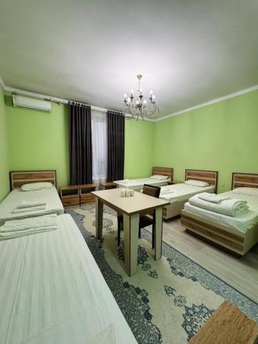 a room with four beds and a table in it at Diamond Hotel Даймонд Отель in Var-Kyshtak