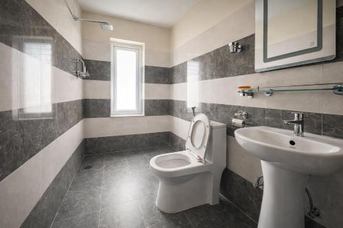 a bathroom with a toilet and a sink at Monastery View Homestay in Kathmandu