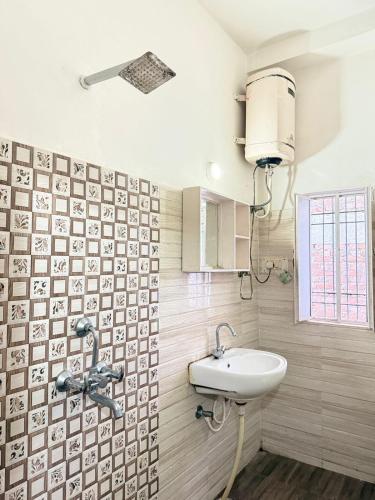 a bathroom with a sink and a faucet at Hotel Arawali Hill in Udaipur