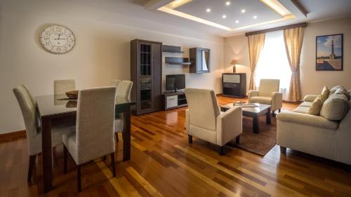a living room with a dining room table and chairs at Feel Belgrade Apartments in Belgrade