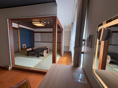 a view of a living room with a mirror at Peace INN Masuda-ekikita in Masuda