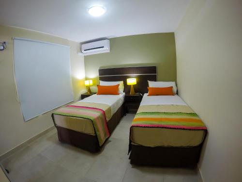 Ένα ή περισσότερα κρεβάτια σε δωμάτιο στο Apart Hotel Lo de Carilo