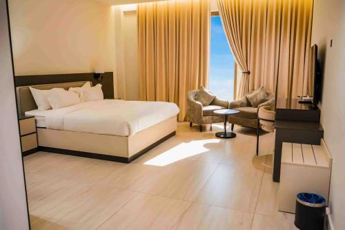 a hotel room with a bed and a chair at فندق جديل2 - Jadeel Hotel 2 in Al Khobar