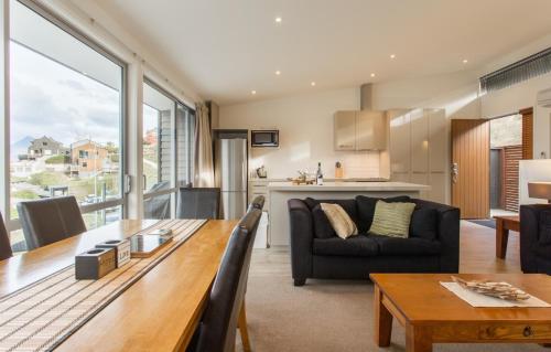 a living room with a table and a couch at Goldrush # 2 in Queenstown