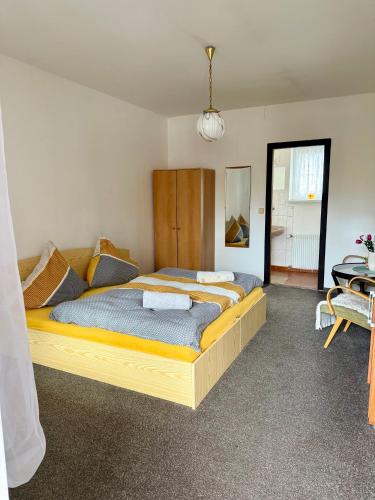 a bedroom with a large bed in a room at U potůčku in Ledce