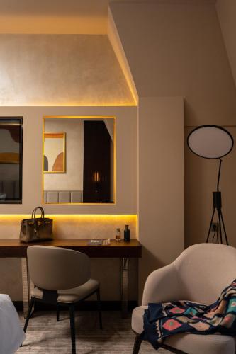 a living room with a desk and a chair at Marhaba Hotel & Spa in Tashkent