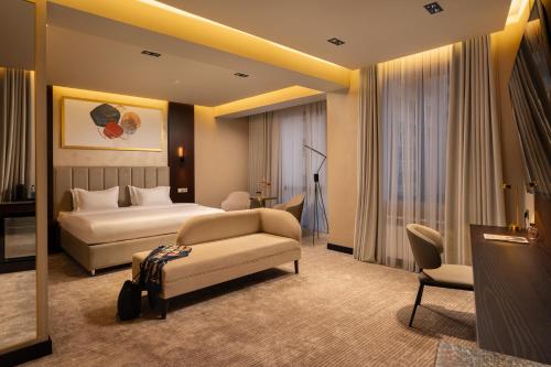 a hotel room with a bed and a couch at Marhaba Hotel & Spa in Tashkent