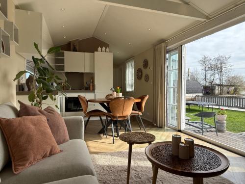 a living room with a couch and a table at NEW - Private Residence with Sauna - on a lake near Amsterdam in Vinkeveen