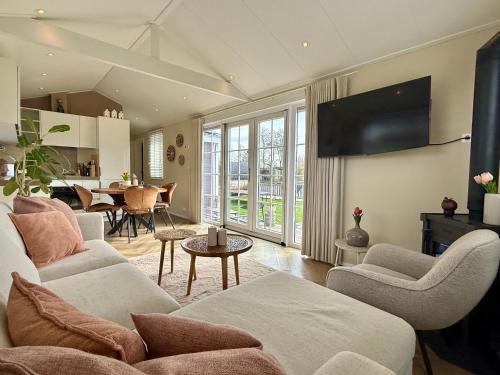 a living room with a couch and a table at NEW - Private Residence with Sauna - on a lake near Amsterdam in Vinkeveen