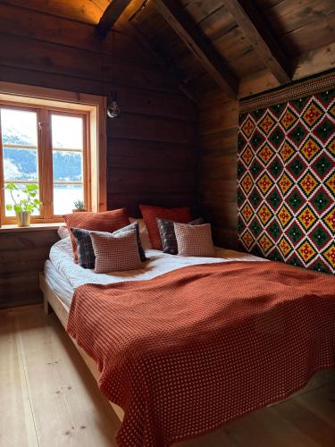 a bedroom with a large bed in a wooden room at Urastova in Vassenden
