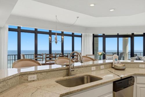 a kitchen with a view of the ocean at The Oasis at Orange Beach 1611 (Phoenix West II) in Orange Beach